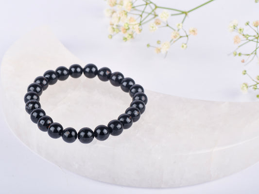 Black Tourmaline stone for absorbing negative energy and promoting healing.