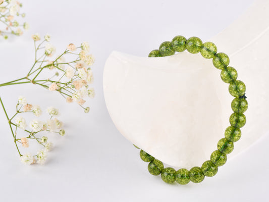 Peridot crystal stone used for positive energy and stress relief.